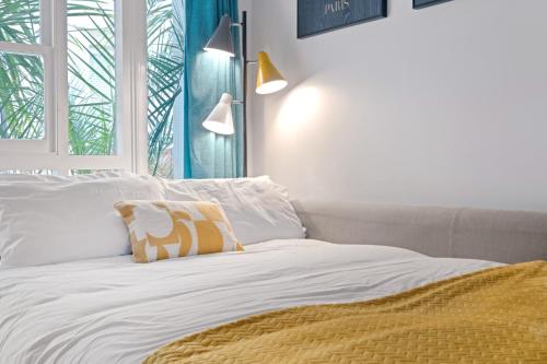 Schlafzimmer mit einem Bett mit weißer Bettwäsche und einem Fenster in der Unterkunft Urban Elegance - 1-2 Bed Luxury City Retreat in Nottingham