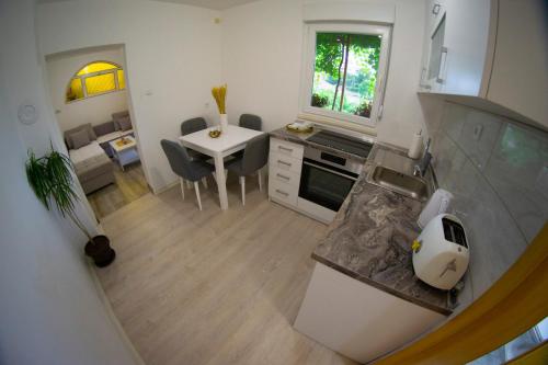 an overhead view of a kitchen with a table at UKROPINA APARTMENTS in Trebinje
