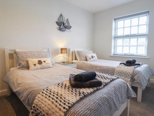 a bedroom with two beds with towels on them at Harbour View in Porthmadog