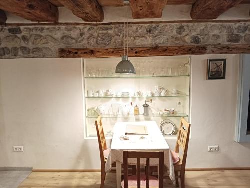 a dining room with a table and chairs and a shelf at Appartement Fassbinder in Hall in Tirol