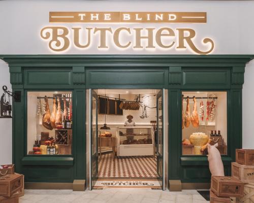 a person taking a picture of the blind butcher sign in a store at Hyatt Zilara Cap Cana - Adults Only in Punta Cana