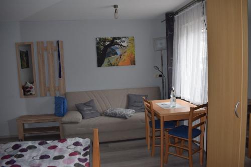 ein Wohnzimmer mit einem Sofa und einem Tisch in der Unterkunft Gaststätte Marktstübchen in Bornich
