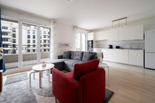 a living room with a couch and a kitchen at Bright T4 with balcony in Saint-Ouen - Welkeys in Saint-Ouen