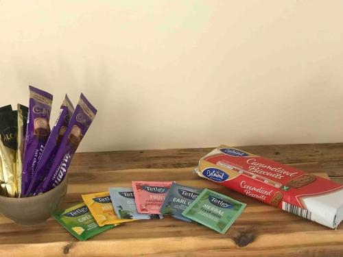 a wooden table with toothbrushes and packets of toothpaste at The Old Coop Barn in Brassington