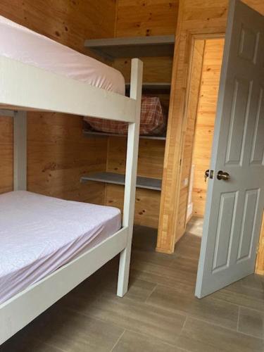 a bedroom with a bunk bed and a open door at Twin Brothers Pichidangui 1 in Pichidangui
