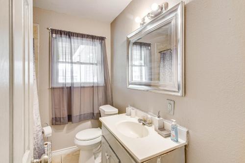 a bathroom with a sink and a toilet and a mirror at Spacious Orange Rental about 3 Mi to Museums and Garden! in Orange