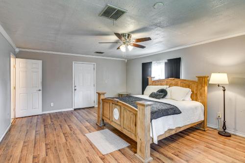 a bedroom with a wooden bed and a ceiling fan at Spacious Orange Rental about 3 Mi to Museums and Garden! in Orange