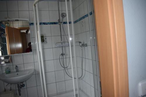 a bathroom with a shower and a sink at Gaststätte Marktstübchen in Bornich