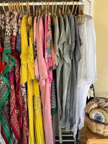 a closet filled with lots of different colored clothes at Mistral Boutique Hotel in Meganisi