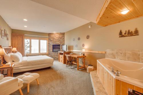 a bedroom with a bed and a tub in a room at Waterfront Two Harbors Condo with Indoor Pool Access in Two Harbors