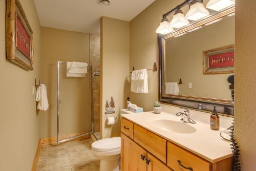 a bathroom with a sink and a toilet and a mirror at Waterfront Two Harbors Condo with Indoor Pool Access in Two Harbors