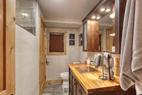 a bathroom with a sink and a toilet at Hygge House on the Creek in Rapid City