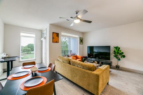 a living room with a couch and a tv at Downtown Apartment with Riverwalk views Free Parking Pet Friendly Centrally Located on the Riverwalk in San Antonio