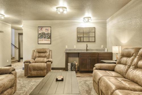 a living room with two couches and a table at Wernski Lodge in Lead