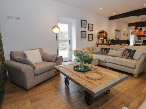 a living room with a couch and a coffee table at Plas Glan Yr Afon in Abergele