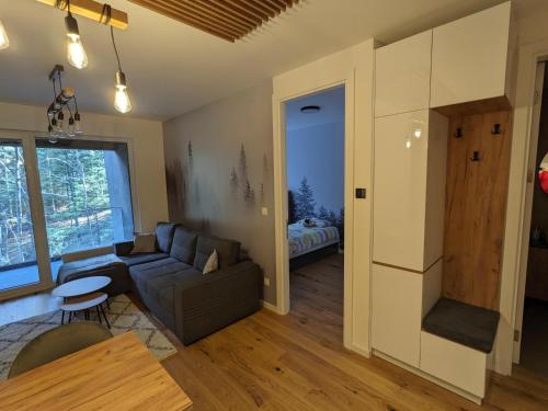 a living room with a couch and a table at Mountain Oasis Bjelasnica in Bjelašnica
