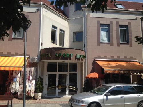 a car parked in front of a clothing store at Hotel Apart Hotel in Hévíz