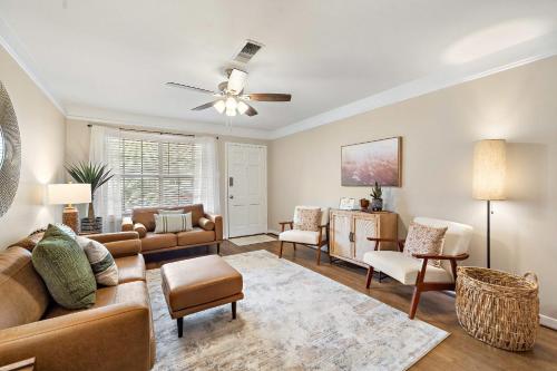 a living room with a couch and a chair at with Arcade and Covered Patio Sleep 9 in this 4 Bedroom 2 Bath Home 5 star host Deer Park TX in Deer Park