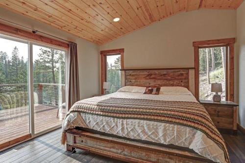 a bedroom with a bed and a large window at Wildercreek Cabin in Lead