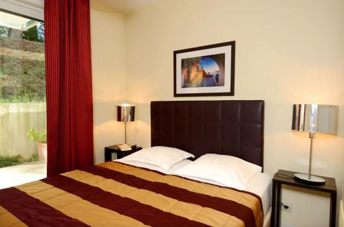 Postel nebo postele na pokoji v ubytování Appart Hotel Odalys City Antibes Olympe