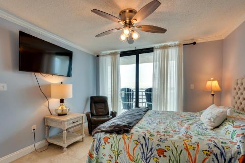 a bedroom with a bed and a flat screen tv at Florida Apartment with Balcony, Pool Access and Views in Panama City Beach