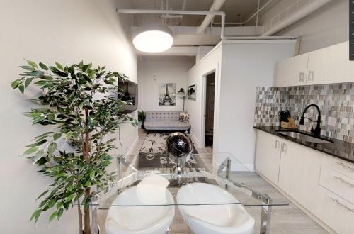 a kitchen with a glass table and a plant at Studio in the heart of downtown in Ottawa