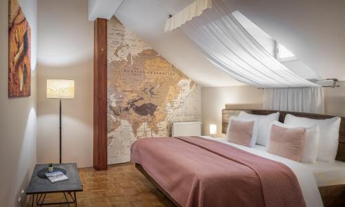 a bedroom with a large bed with a map on the wall at 6 Continents Apartments by Adrez in Prague