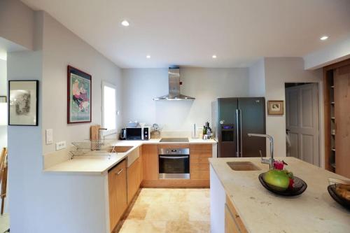une cuisine avec un réfrigérateur et un plan de travail dans l'établissement Villa Lacoste Luberon piscine 4 ch 4 sdb (+ clim), à Lacoste