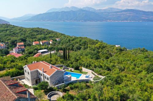 an aerial view of a house with a swimming pool at Villa Vista Azzurra in Tivat