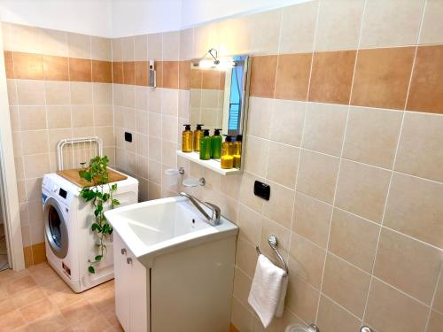 a bathroom with a washing machine and a sink at In centro a due passi dal lago in Iseo