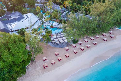 an aerial view of a beach with umbrellas and chairs at Colony Club, a Luxury Collection Resort, Barbados in Saint James