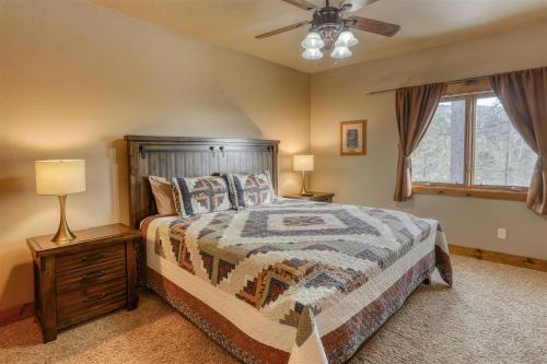 a bedroom with a bed and a ceiling fan at Westwinds Lodge in Lead