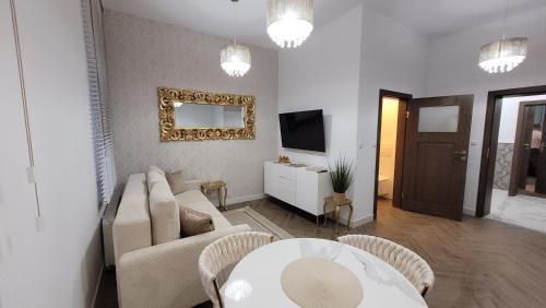a living room with a couch and a table at Apartament Jaracza 28/7 in Słupsk
