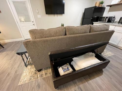 a couch sitting in a living room with a box at Baytown Private Studio Apartment covered patio Sleeps 4 by the bay skate park main street water park in Baytown