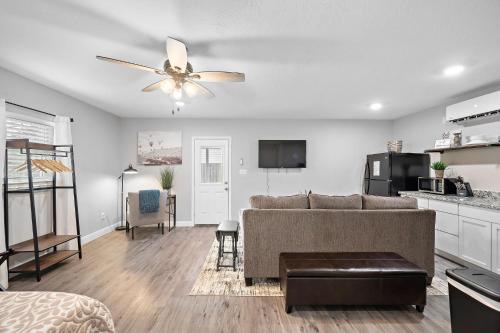 a living room with a couch and a ceiling fan at Baytown Private Studio Apartment covered patio Sleeps 4 by the bay skate park main street water park in Baytown