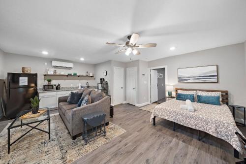 a living room with a couch and a ceiling fan at Baytown Private Studio Apartment covered patio Sleeps 4 by the bay skate park main street water park in Baytown