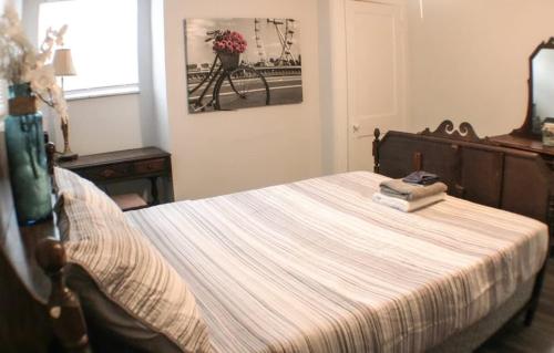 a bedroom with a bed with a striped blanket at Massive 4 Bed House-Short Walk to Amazing View in Pittsburgh