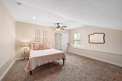 a bedroom with a bed and a ceiling fan at Old and Lost River Home on the river by Super Hosts instant book barbers hill wifi work space fishing hunting bird watching in Baytown