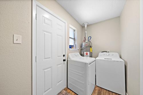 a white laundry room with a washer and dryer at Sandy Private Beach Oasis Close to Kemah Boardwalk & NASA 5 STAR SUPER HOST in Seabrook