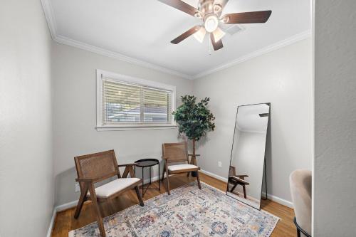 a living room with a ceiling fan and chairs at Kick Back & Relax WiFi Desk Smart TVs Tire swing in Pasadena