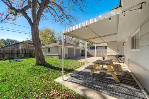 a picnic table under awning outside of a house at Kick Back & Relax WiFi Desk Smart TVs Tire swing in Pasadena