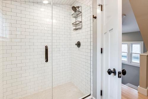 a bathroom with a shower with white subway tiles at Luxury Condo, Steps to Downtown Montclair and Train! in Montclair