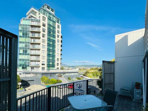 a balcony with a view of a tall building at Wrights by the Sea Motel in Paraparaumu Beach