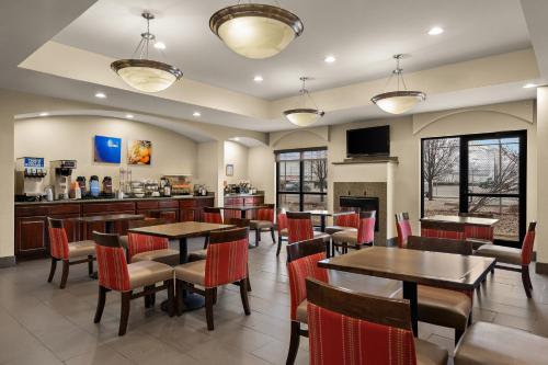 a restaurant with tables and chairs and a bar at Comfort Inn Ogden near Event Center in Ogden