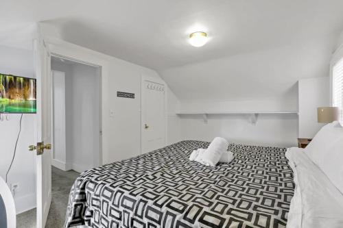 a bedroom with a bed with a black and white comforter at Housepitality - The Marienplatz - Free Parking in Columbus