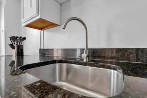 a kitchen sink with a faucet on a counter at Housepitality - The Marienplatz - Free Parking in Columbus