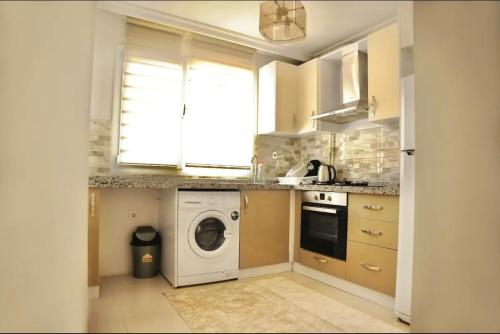 a kitchen with a washing machine and a window at ISTANBUL APARTMENT Stylish&Lively in Istanbul