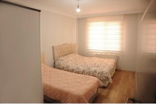 a bedroom with two beds and a window at ISTANBUL APARTMENT Stylish&Lively in Istanbul