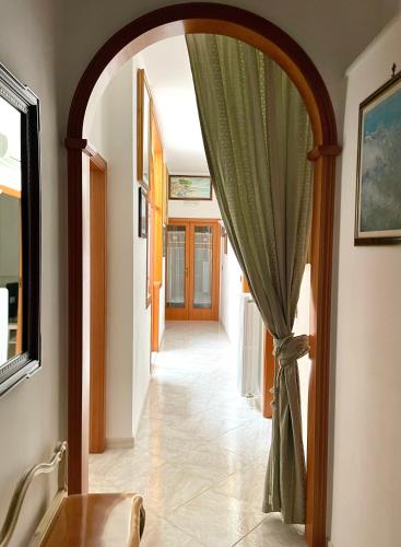an arched doorway with a curtain in a hallway at Seafront View in Mola di Bari