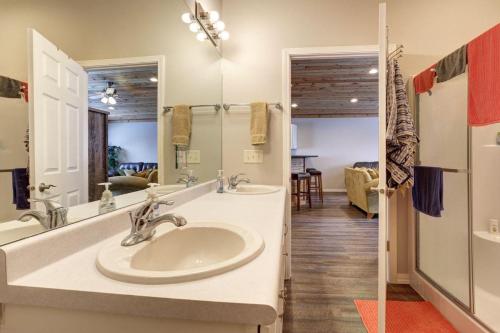 a bathroom with two sinks and a large mirror at Thunder Ridge Loft in Lead